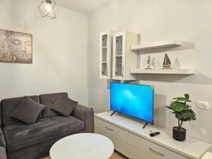 a living room with a couch and a flat screen tv at 07 Apartment Vlore in Vlorë