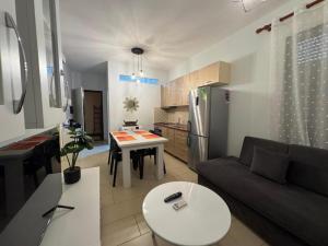 a living room and kitchen with a couch and a table at 07 Apartment Vlore in Vlorë