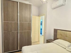 a bedroom with a bed and a large closet at 07 Apartment Vlore in Vlorë +12 photos