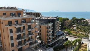 an aerial view of a building with the ocean in the background at 07 Apartment Vlore in Vlorë