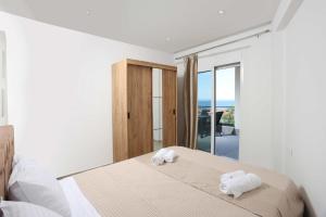 a bedroom with a bed with two towels on it at Local View Apartments in Polychrono
