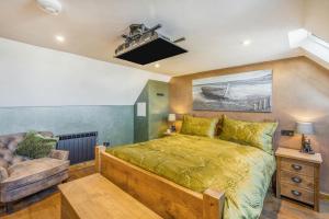 a bedroom with a large bed and a couch at 1 Bed in Banff oc-t42474 in Banff