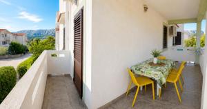 a patio with a table and chairs on a balcony at Apartments Mohar II in Baška +26 photos