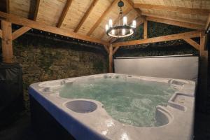 a jacuzzi tub in a building with a wooden ceiling at 1 Bed in Banff oc-t42474 in Banff +30 photos