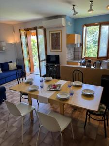 a dining room and living room with a table and chairs at Oasi in Desenzano del Garda