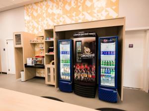 two soda machines in a store with drinks at IBIS BUDGET CAPAO Bonito in Capão Bonito