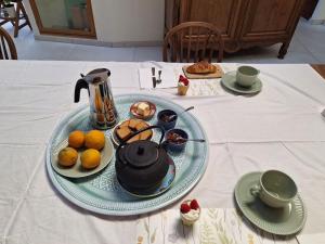 a table with a plate of food on a table at La chambre de Jeanne in Toul