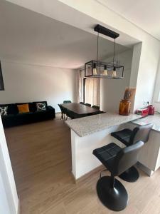 a kitchen and living room with a table and chairs at Casa Rosarinho in Faro