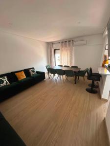 a living room with a couch and a table and chairs at Casa Rosarinho in Faro