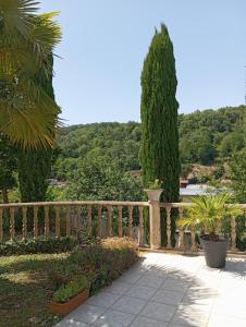 a wooden fence in a garden with trees at Les Cyprès in Vienne