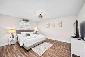 a bedroom with a bed and a flat screen tv at Prairie Falls in Post Falls