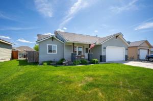 a house with a flag in a yard at Prairie Falls in Post Falls