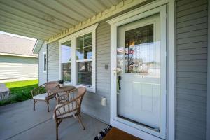 a porch with a table and chairs and a door at Prairie Falls in Post Falls +20 photos