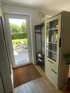 a room with a door leading to a patio at Ferienwohnung Meding am See in Schondorf am Ammersee