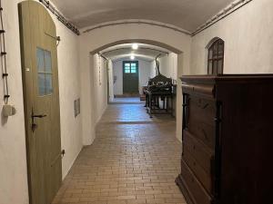 an empty hallway with a room with a piano in a house at Herrenhaus Libnow in Murchin +81 photos