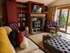 a living room with a couch and a fireplace at 5 Bed in Hundleby oc-o44769 in Spilsby