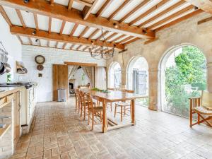 a kitchen with a wooden table and chairs at The Barn - Uk51594 in Grantham