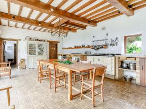 a large kitchen with a wooden table and chairs at The Barn - Uk51594 in Grantham