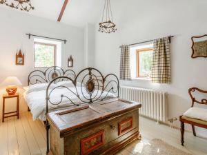 a bedroom with a bed and a wooden chest at The Barn - Uk51594 in Grantham +16 photos