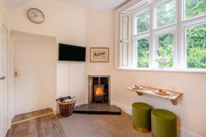 a living room with a fireplace and a clock on the wall at 1 Bed in Exton oc-e42799 in Exton