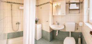 a bathroom with a sink and a toilet and a shower at Apartments Mohar III in Baška +15 photos