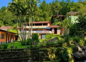 a view of a house from the water at Sítio do vô Hélio - Petropolis in Araras Petropolis