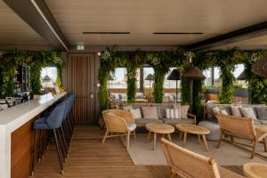 a restaurant with tables and chairs and a bar at Grand Hotel Bellevue - Grand Place in Lille