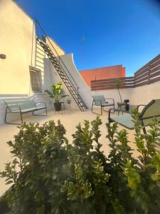 a patio with benches and stairs in a building at La Terrazza in centro in Marsala
