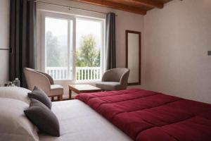 a bedroom with a large red bed and a window at The Oak Lake Cottage Boho in Nainital