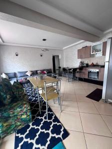 a living room with a couch and a table at Garden Beach 2 in Sidi Rahal