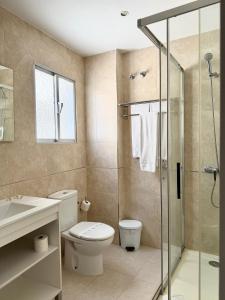 a bathroom with a toilet and a glass shower at Hotel Victoria Centro in Almuñécar