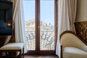 a room with a window with a view of the city at L'étoile d'Arras in Arras