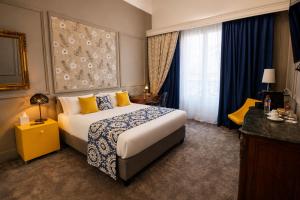 a hotel room with a bed and a window at Grand Hotel Bellevue - Grand Place in Lille