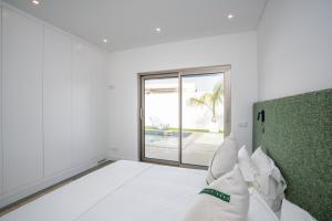 a white room with a bed and a window at Villa Bazaruto in Lagos +67 photos