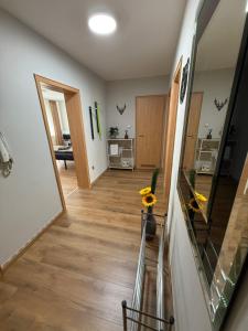 a room with a hallway with a mirror and a table at CAL Apartments in Duisburg
