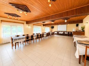 a large room with tables and chairs and a chalkboard at Pensiunea Sub Piatră in Sălciua de Sus