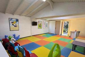 a room with a colorful floor with a table and chairs at Anita Matiate Hotel in Beldibi