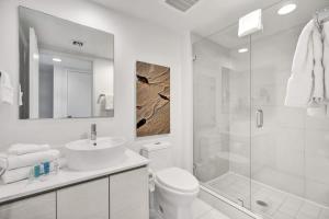 a white bathroom with a sink and a shower at Ocean & Canal View Studio Beach 8 Min Pool 1906 in Hallandale Beach