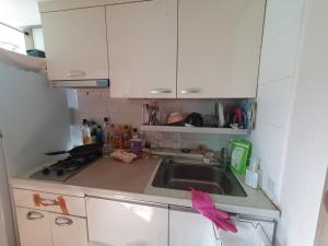 a kitchen with a sink and white cabinets at 1room 1bed Gangnam in Samgong