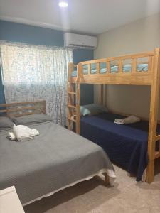 two bunk beds in a small room with blue walls at Yara Beach in Punta Cana +7 photos