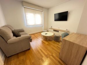 a living room with a couch and a table at Candle Home Sáenz Díez in Ourense