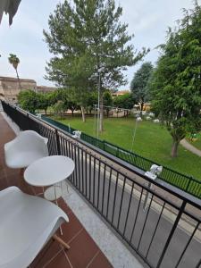 a balcony with tables and chairs and a park at b&b la Conocchia in Curti