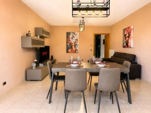 a dining room and living room with a table and chairs at La Perla in Passignano sul Trasimeno