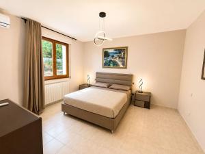a bedroom with a bed and a window at La Perla in Passignano sul Trasimeno