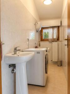 a bathroom with a sink and a small refrigerator at La Perla in Passignano sul Trasimeno +10 photos