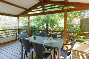 a patio with a table and chairs on a deck at Azur de La Cigale -Conciergerieland in Azur
