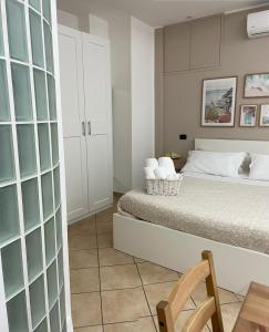 a bedroom with a bed and a wooden chair at Carla's studio in Pompei +59 photos