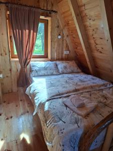 a bedroom with two beds in a log cabin at Vikendica Smolovic in Žabljak