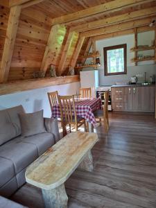 a living room with a couch and a table at Vikendica Smolovic in Žabljak