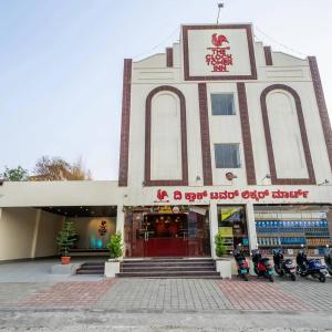 a building with motorcycles parked in front of it at The Clock Tower Inn in Bangalore